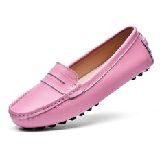 a pink loafer with spikes on the bottom and black soles, in front of a