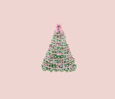 a small christmas tree with pink and green decorations