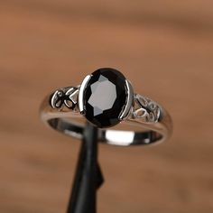 It is a natural black spinel ring. The main stone is 7mm*9mm oval cut, weight about 2.16 carats.The basic metal is sterling silver and plated with rhodium.To change the metal to a solid gold (white/rose) or platinum is also available, please ask for a quotation if you want.You can also go to my shop Home for more elegant rings: https://www.etsy.com/shop/godjewelry?ref=hdr_shop_menuMore rings:https://www.etsy.com/shop/godjewelry?ref=l2-shop-header-avatarCustomization is always welcome and please Rainbow Topaz Ring, Silver Solitaire Engagement Ring, Half Bezel Setting, Elegant Rings, Black Spinel Ring, Black Diamond Solitaire, Swiss Blue Topaz Ring, Half Bezel, Spinel Ring