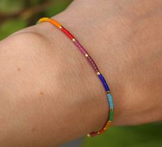 LGBTQ bracelet, made with very tiny Miyuki delica glass beads in the rainbow colors. This minimalist pride bracelet has a stainless steel gold lobster clasp. It is a very thin and subtle bracelet! This colorful beaded bracelet is perfect as a minimal summer bracelet! Just looking at it makes me happy :-) Also available in silver: https://www.etsy.com/be/listing/1111853627/lgbtq-bracelet-pride-bracelet-subtle?ref=shop_home_active_1&frs=1 Materials: -11/0 Miyuki delica's (1.6mm x 1.3mm) -stain Lgbtq Bracelet, Lgbt Bracelet, Minimal Bracelet, Pride Jewellery, Bracelet Miyuki, Pride Bracelet, Bracelet Rainbow, Miyuki Bracelet, Turquoise Bead Bracelet