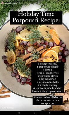 a holiday time recipe with oranges, apples and cinnamon sticks in a bowl on a table