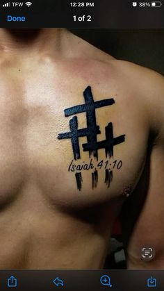 a man's chest with a cross tattoo on it