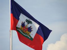 the flag of the state of new york flies high in the blue, white and red sky