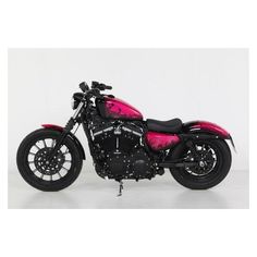 a pink and black motorcycle parked on top of a white floor