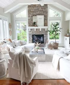 a living room filled with furniture and a fire place in the middle of a room