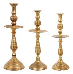 three brass candlesticks are shown on a white background