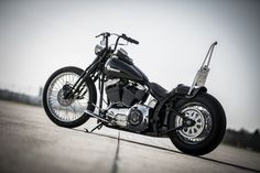 a black motorcycle parked on top of a parking lot