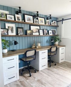 an office with two desks and several framed pictures on the wall above each desk