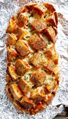 a cheesy bread dish on aluminum foil