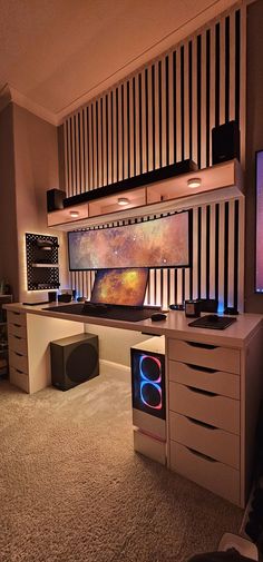 a room with a desk, television and speakers