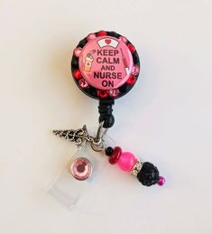 Badge reel This cute badge reel is handmade and comes with a very cute charm and dangling beads as shown in the pic. Show off your new handmade badge reel to all your co-workers All badge reels come on a slide clip! Alligator swivel clip upon request Pink Badge Holder With Swivel Clip As Gift, Pink Badge Reel With Swivel Clip As Gift, Fun Pink Badge Holders For Gift, Adjustable Novelty Pink Badge Holders, Pink Personalized Novelty Badge Reel, Novelty Pink Personalized Badge Reel, Fun Pink Badge Reel For Gift, Personalized Pink Novelty Badge Reel, Novelty Personalized Pink Badge Reel