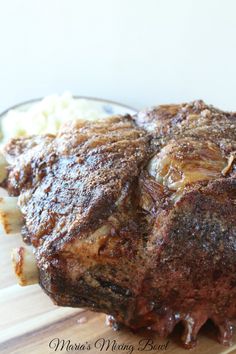 some meat and potatoes on a wooden cutting board