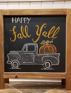 a chalkboard sign that says happy fall and an old truck with pumpkins on it