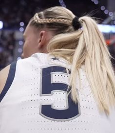 a female basketball player wearing a ponytail with her hair in a high pony tail braid