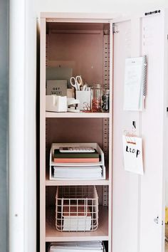 a pink bookcase filled with lots of books