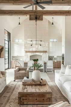 a living room filled with furniture and a fire place in the middle of an open floor plan