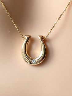 "Hanging a horseshoe facing upwards in a \"U\" shape is said to keep evil out and bring good luck and protection. Whether you believe the legend or not, you have to admit, this lucky horseshoe necklace makes interesting jewelry you must have!  Proudly Handmade in Montréal Canada   If you want your birthstone, we can do it!!  Details: Metal Purity: 14K Gold Height : 17mm  Width: 15mm  Stone: Natural Diamond Quality: VS-H Size: 0.05ct Weight:  4.3g Approximately Condition: New Please understand that the photos are ENLARGED to show detail for your benefit- please use the measurements provided in the item details/description to understand the size of the gem or Jewelry in the listing- measurements are given in millimeters unless otherwise noted. Please check the photos & sizes in the descripti Horseshoe Pendant Necklaces, Woman Gold Necklace, Horse Shoe Necklace, Horseshoe Necklace Gold, Equine Jewelry, Horseshoe Jewelry, Interesting Jewelry, Necklace With Diamond