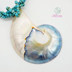 The White Nautilus shell is from Netherland and crafted in Indonesia. The Necklace is made of small Light blue Racine beads string together each bead to be a beading line and twist each line to be one line to stronger and look beautiful, and it is 18 inches long, weight 45g. (including pendant)   It's a real seashell from farming which it's fed by the seaweed, not from the natural environment due to environmental conservation. Our product was crafted with craftsmanship from one generation to one generation, and it may not last forever. Unlike a product that is made by machine. It's not just an ordinary necklace but it's about the taste of the wearer. It's for you or anyone who infatuates nature which each of the shells may look alike but not the same in color and texture. It's very UNIQUE. Nautilus Shell Necklace, Ocean-inspired Shell-shaped Mother Of Pearl Jewelry, Ocean-inspired Shell-shaped Pearl Pendant, Adjustable Shell-shaped Mother Of Pearl Necklace, White Abalone Shell-shaped Necklace, Nautilus Shell, Ancient Animals, Small Light, Bead Stringing