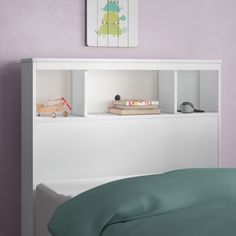 a bed with purple walls and a white bookcase on the headboard in front of it