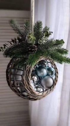 a christmas ornament hanging from the side of a window with ornaments in it