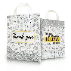 two white bags with black and yellow designs on them, one has the words thank you to leave