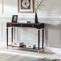 a black console table with two vases on it