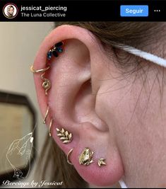 a woman wearing ear piercings with leaves and flowers on her left side behind the ear