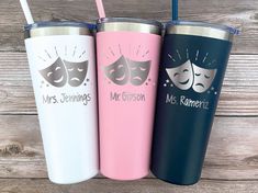 three personalized travel mugs with masks on the side, one pink and one blue