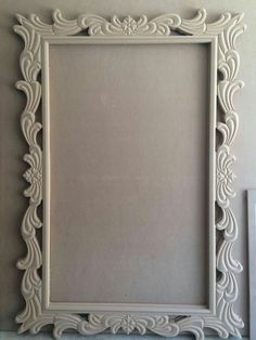 an ornate white frame on the wall