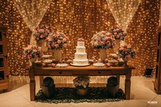 a table topped with a cake surrounded by flowers