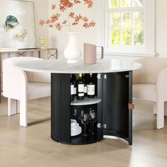 a dining room table with wine bottles and glasses on it