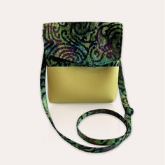 Multi-colored Batik on a beautiful green tie dye background with a yellow vinyl bottom! This eye-catching handmade bag is certainly a piece that you need to add to your bag collection. The bag is fully lined with sturdy, lightweight Cordura fabric, adding structure to the bag body. This bag also comes with an extra long strap for a comfortable fit! Large zippered interior pocket will keep your valuables easy to access and safe from loss.   Bag Dimensions when closed: 8 inches high, 7.5 inches wide, 1.75 inches deep at bottom Zipper Dimensions: 6.5 inches wide, 6.5 inches deep Strap Length: 53 inches Tie Dye Background, Green Tie Dye, Bag Green, Bag Collection, Green Tie, Handmade Bag, Green Bag, Crossbody Purse, Handmade Bags