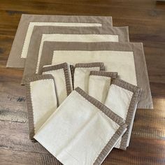 five placemats and four napkins on a wooden floor