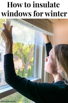 a woman is looking out the window with her hands in the air and text overlay reads how to insulate windows for winter