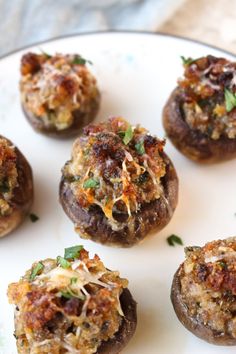 several stuffed mushrooms are on a plate with parmesan cheese