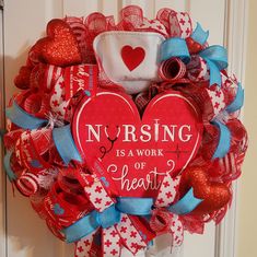 a wreath that says nursing is a work of heart surrounded by red, white and blue ribbons