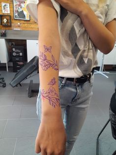 a woman with a flower tattoo on her arm