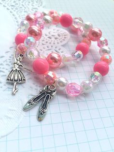 "Ballet party, Ballerina party, ballerina bracelet, ballerina jewelry, dance recital, ballet bracelet, ballet party favor. SET of TEN. Party planning is already so stressful. Leave the favors up to us! This listing is for (10) child sized bracelets. DETAILS and MEASUREMENTS: Beads vary in sizes from 6mm-10mm. The length of a bracelet is 6.5\" (we can make them smaller or bigger for you). COLOUR & CHARM CHOICES: If the bracelet does not match your party theme exactly, just send us a note. We love Adjustable Pink Charm Bracelet For Party, Pink Adjustable Charm Bracelet For Parties, Whimsical Adjustable Beaded Bracelets For Party, Pink Adjustable Stretch Bracelet For Party Favors, Whimsical Pink Bracelets For Birthday, Whimsical Pink Charm Bracelet For Birthday, Pink Bracelet For Party Favors, Pink Handmade Stretch Bracelet For Party, Handmade Pink Bracelets For Party Favors