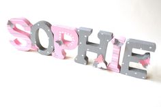 the word hope is made out of wooden letters with butterflies on them and pink, gray and white stripes