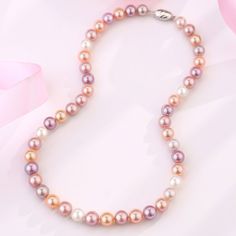 Choose this lavish AAA or AAAA multicolored freshwater pearl strand necklace for a dose of show-stopping color and mesmerizing uniqueness of these wondrous pearls. Colored pearls display harmonious body colors that uplift your wardrobe to another level of elegance. This classic single-strand necklace features completely natural lavender and pink fine quality AAA or AAAA pearls shimmering with pastel overtones and a bright luster. Unique and captivating, these high-quality lavender freshwater pea Multicolor High Luster Necklaces As Gift, Multicolor High Luster Necklace For Gift, Multicolor Round Beads Necklace With Pearl Drop, Elegant Pearl Necklaces With Colorful Beads, Multicolor High Luster Round Beaded Jewelry, Elegant Multicolor Beaded Necklaces With Pearl Charm, Elegant Pearl Necklace With Colorful Beads, Elegant Multicolor Beaded Necklaces, Colorful Beaded Round Pearl Necklace Gift