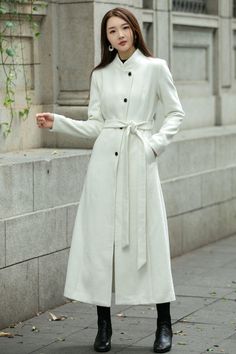 This woman long wool coat in white is a timeless winter piece that will add a divine pop of color to your winter wardrobe.  This coat is a stunning color, lovely length, and keeps me warm.  Endlessly versatile, layer it over jeans and sweaters or sleek dresses for countless styling options.  ★★FEATURES 50% wool blend, 50% polyester Polyester lining Single breasted coat A Line Belted coat Long sleeve High collar Two side pockets Perfect for winter, autumn Dry clean ★★ The model's height approx 170 cm (5′ 7″) with the 84 cm (33") bust, 66 cm (26") waist. She is wearing the wool dress in size XS (US2) ★★Bespoke Order Service Request other color Request the Length Request the sleeve length Your height is not between 155cm- 175cm Your weight is not between 47kg -77kg  ★★ Get your size in Size C Sleek Dresses, A Line Coat, Wedding Coat, Sleek Dress, Coat Autumn, Wool Trench Coat, Long Wool Coat, Single Breasted Coat, Winter Outerwear