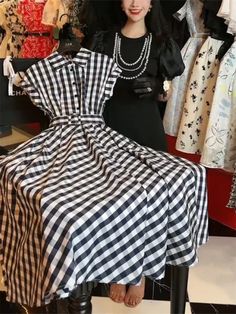 This elegant dress features slight stretch fabric and a slim fit silhouette, making it ideal for the office or a summer event. The design includes a polo collar, high waist, and A-line shape, all made from polyester with a plaid pattern. It has short sleeves, a mid-calf length, and a belt for decoration. This sophisticated dress is perfect for women looking for a stylish and comfortable option, and is made from synthetic fibers in China. The dress also has a single-breasted closure, an empire waistline, and a release date of Summer 2024. Black A-line Shirt Dress, Black A-line Shirt Dress For Spring, Knee-length Shirt Dress For Summer Evenings, Summer Evening Knee-length Shirt Dress, Classic Collared Party Dresses, Collared Black Midi Dress For Summer, Black Collared Midi Dress For Summer, Black Collared Shirt Dress For Summer, Casual Black A-line Shirt Dress