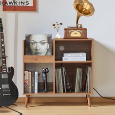 an old record player is sitting next to a bookcase with books and records on it