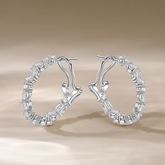 These stunning hoop earrings adorned with an array of multi-shaped stones. These exquisite earrings are a true celebration of diversity and individuality, featuring a mesmerizing display of stones in various shapes and sizes that come together to create a harmonious and vibrant composition. Wear these hoop earrings for a bold and expressive display of your unique style and personality.Carat Weight: 2.651 ctStone Size: 2*3,2 mmStone Type: Jeulia® StoneNumber of Stones: 32 Stone Color: Diamond Whi Elegant Sterling Silver Hoop Crystal Earrings, Elegant Hoop Crystal Earrings For Anniversary, Fine Jewelry Hoop Earrings For Party, Sterling Silver Hoop Earrings, Sterling Silver Hoops, Online Earrings, White Stone, Silver Hoops, Silver Hoop Earrings