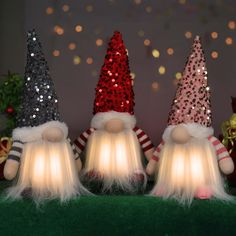 three christmas gnomes with lights on their heads