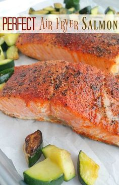 two salmon fillets with zucchini and potatoes on a white plate next to the words perfect air fryer salmon