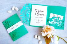 the wedding stationery is laid out with flowers