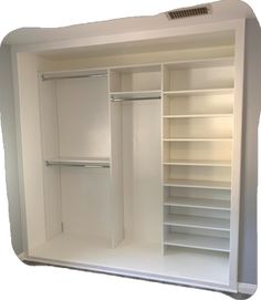 an empty walk in closet with white shelves