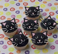 cupcakes with black frosting and cat faces on them