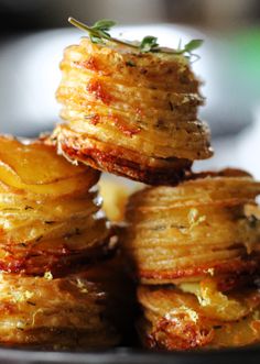 some food that is stacked on top of each other in a black plate with silverware